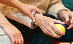 a pair of young hands grasping old hands