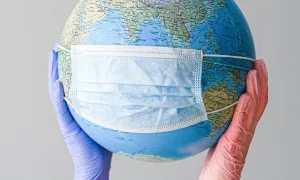 a humorous picture of a globe wearing a medical mask