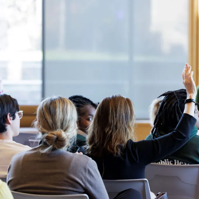 "student raising hand in class"