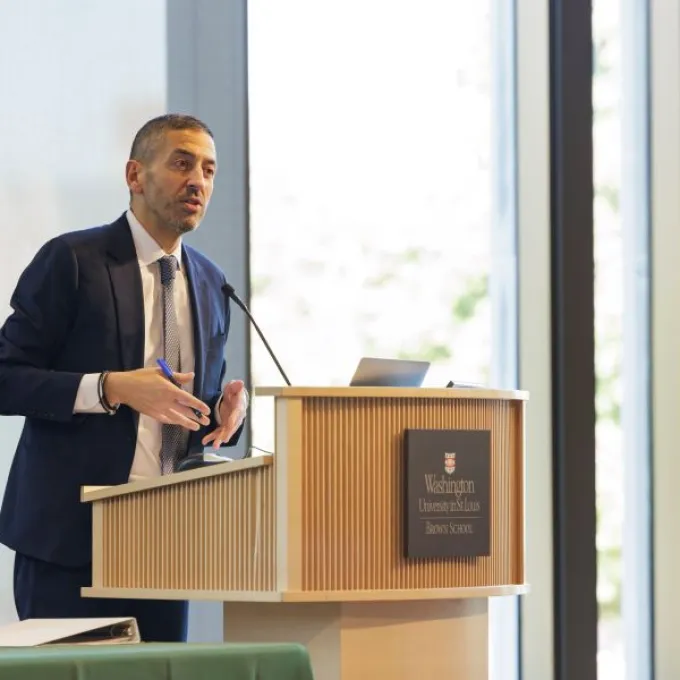 "Dean Galea speaking at podium"