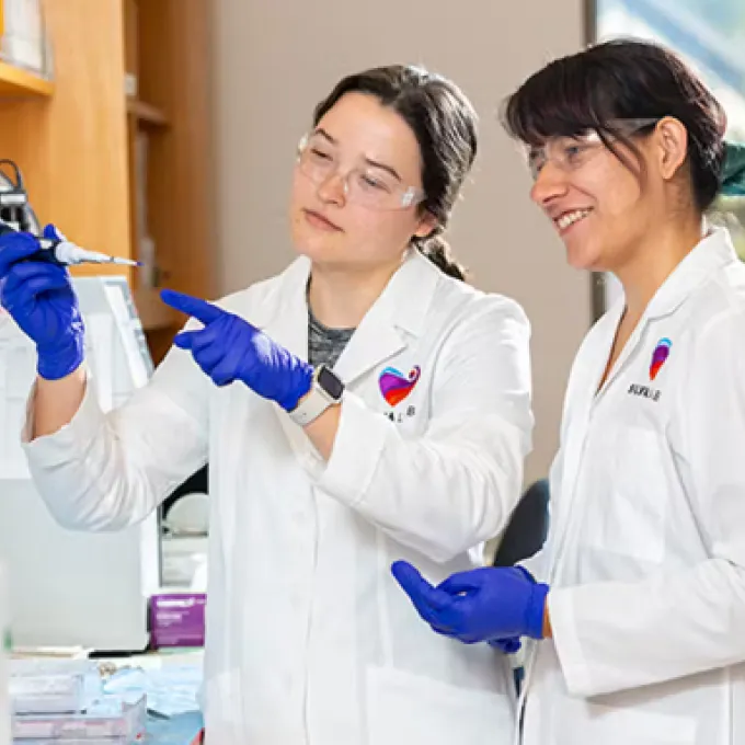 Postdoctoral scholar Heather Struckman in the lab sharing new research methods with BME doctoral student Erica Marquez. Many postdoctoral trainees will mentor a PhD, undergraduate or high school student during their training.