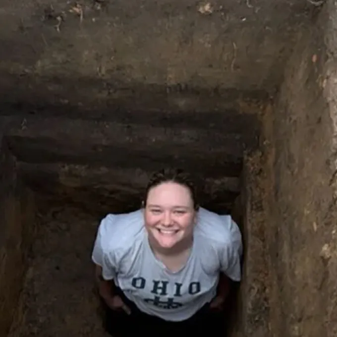 Olivia Baumgartel, a graduate student in archaeology, poses for a photo at a dig site. (Photo courtesy of Kidder and Baumgartel)